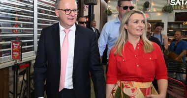 Former university protester Anthony Albanese has made reducing student debt and encouraging more Australians to buy an electric vehicle the hallmarks of his campaign (he is pictured with fiancée Jodie Haydon campaigning in Brisbane)