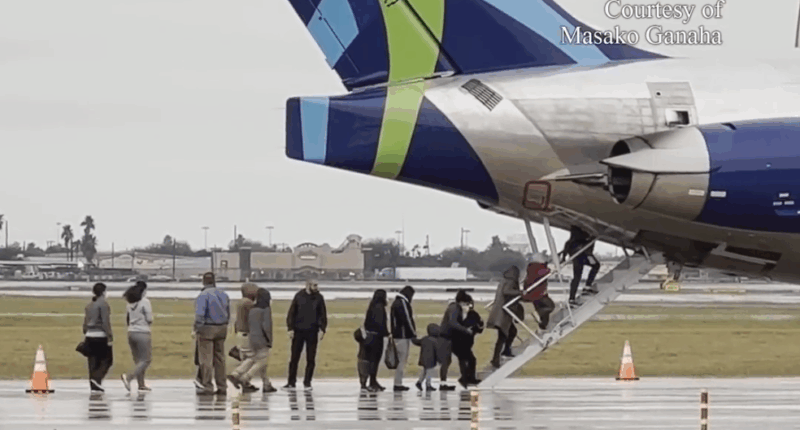 families boarding a plane on a tarmac