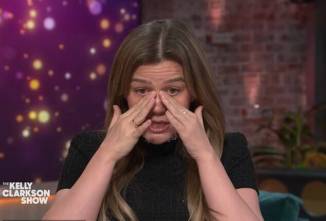 Clarkson wiped away tears during the 1,000th episode of her talk show, and made a cryptic comment that she had 'lost a lot'