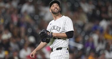 Jacob Stallings, usually a catcher, smiles as he watches one of his pitches fly over his head