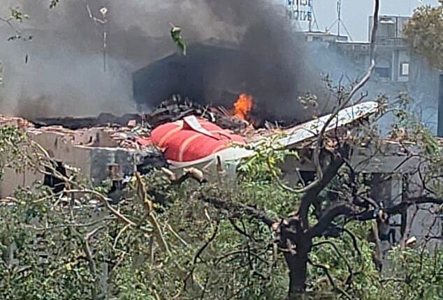 Chunks of the plane's fuselage and tail were seen protruding from a demolished building