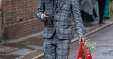 One man is pictured wearing a box over his head the morning after the Trinity Ball at Cambridge