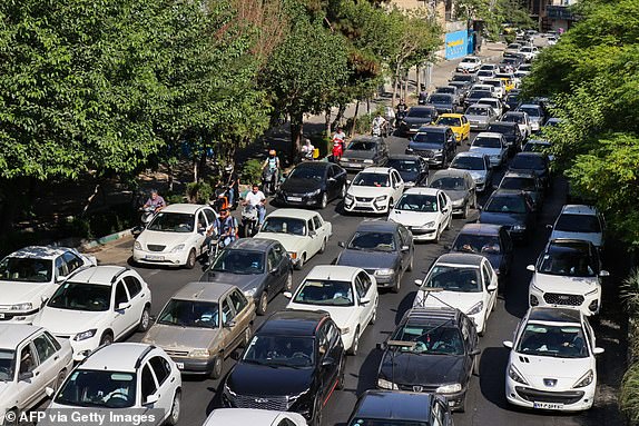 Vehicles await in traffic as people get out of Tehran through an artery in the city's west on June 15, 2025. Iranian media said an Israeli strike hit the Tehran police headquarters in the city centre on June 15, as the two foes exchanged fire for a third day. (Photo by Atta KENARE / AFP) (Photo by ATTA KENARE/AFP via Getty Images)