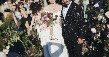 Blushing bride Daisy Lowe cradled her daughter Ivy as she walked down the aisle with new husband Jordan Saul in striking new wedding snaps