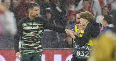 Cristiano Ronaldo grabbed by pitch invader ahead of Portugal's clash with Germany - as stewards are forced to step in after security breach