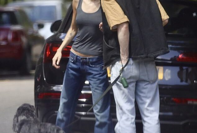 Sharing a tender kiss in the sunshine, these exclusive pictures prove Emma Corrin has moved on after splitting from Hollywood star Rami Malek