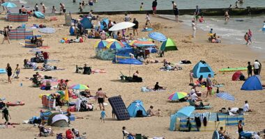 BOURNEMOUTH -- People bask in the 31C heat in southern England today as they flocked to the town's sandy beach, but things are about to get even hotter