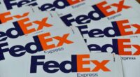FedEx hopes to save $1 billion this fiscal year. But its profit forecast is still sinking shares, as tariffs weigh on shipments.