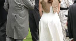 A kiss for Fergie! The King pecks the hand of Sarah Ferguson at the Berkshire racecourse
