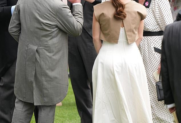 A kiss for Fergie! The King pecks the hand of Sarah Ferguson at the Berkshire racecourse