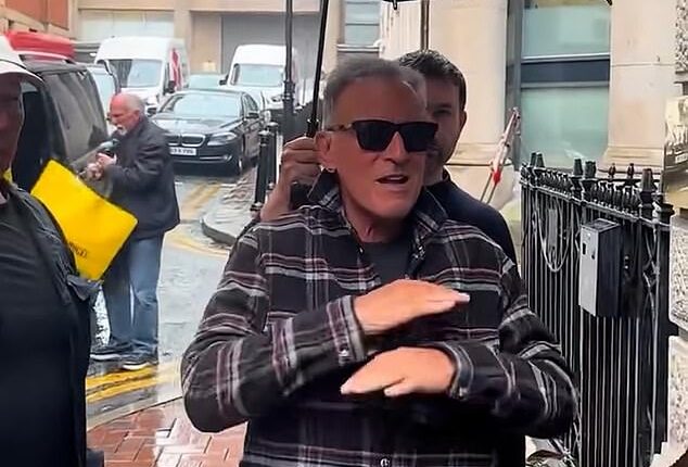 Bruce Springsteen looked furious as he refused to sign autographs for fans waiting in the rain in Manchester