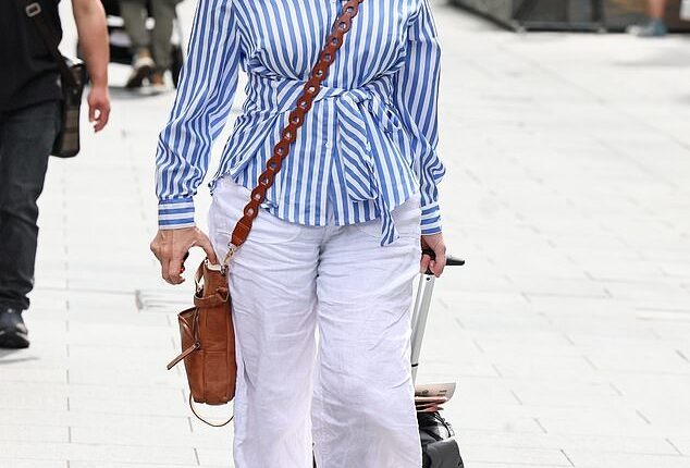 Kate Garraway has revealed that she once had bailiffs turn up at her door while her late husband Derek Draper was in a coma (pictured on Friday)