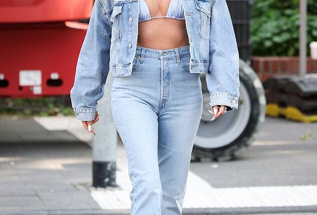 Heidi Klum sent pulses racing in a bikini top and double denim as celebrated her latest billboard shoot for Calzedonia on Monday