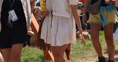 Holly Willoughby got into the festival spirit as she milled around Glastonbury with a drink in hand on Friday