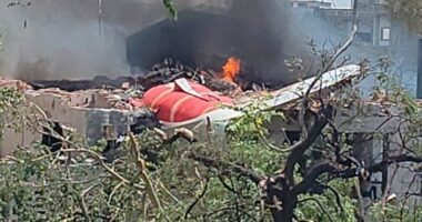 Chunks of the plane's fuselage and tail were seen protruding from a demolished building