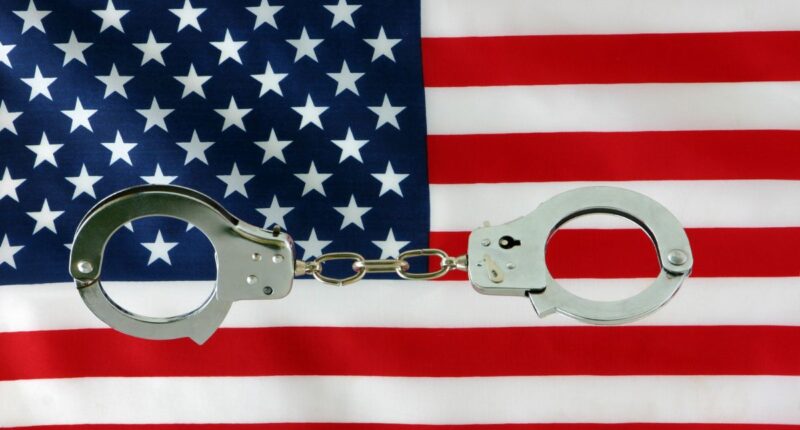 handcuffs over American flag