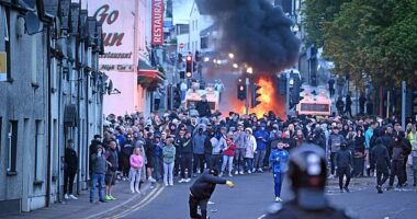 Racially motivated rioters set fire to property and launched fireworks and missiles at police lines