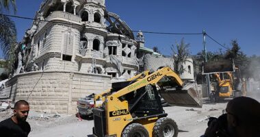 Municipal workers clear the wreckage and debris in the northern Israeli town of Tamra, following an overnigh missile attack from Iran on June 15, 2025, where four people were reported killed. Israel unleashed a punishing barrage of strikes targeting the capital Tehran on June 15, after Prime Minister Benjamin Netanyahu vowed to make Iran pay "a very heavy price" for killing civilians, on the third day of fierce fighting. (Photo by AHMAD GHARABLI / AFP) (Photo by AHMAD GHARABLI/AFP via Getty Images)
