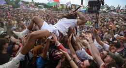 Bob Vylan crowdsurfs in front of the West Holts stage during day four of Glastonbury festival