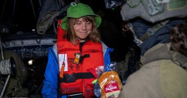 The climate campaigner-turned-Palestine freedom fighter, safe in an orange life jacket and a green frog-shaped sun hat, gazing at the Israeli sandwich with a hungry smile