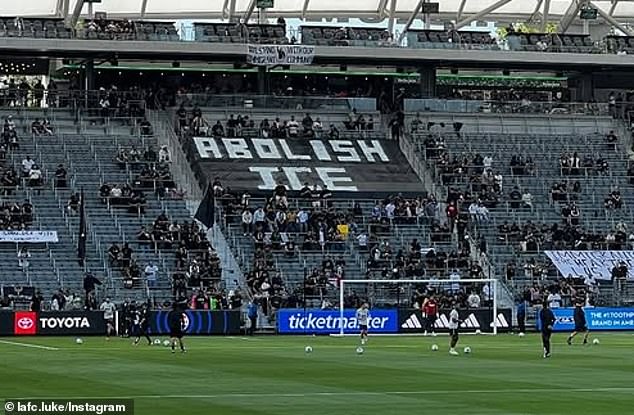 Fans are seen unfurling an Abolish ICE banner prior to Sunday's game against Kansas City