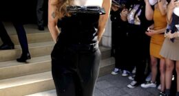 Miley Cyrus, 32, looked chic in a black jumpsuit as she greeted adoring fans who waited for her outside her hotel in Paris on Wednesday