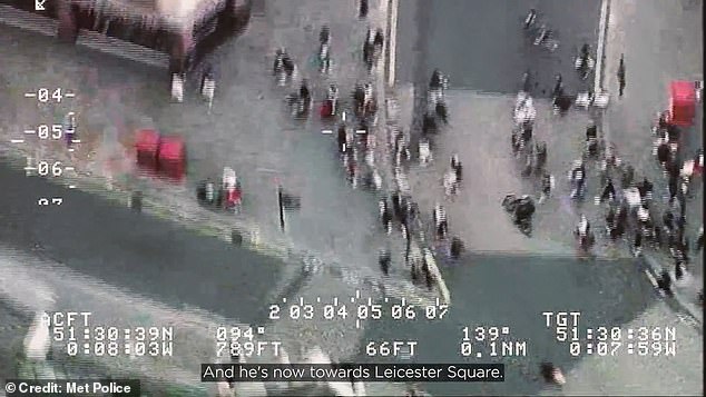 The dramatic moment an alleged phone thief on an e-bike cuts through a crowd of pedestrians in Piccadilly Circus as he tries to outrun police