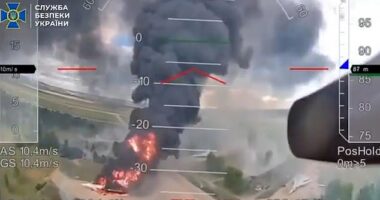 A column of flames and black smoke rises over a targeted plane during Ukraine's Operation Spiderweb