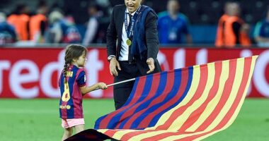 Xana plants a Barcelona flag in centre circle after her father won the 2015 Champions League