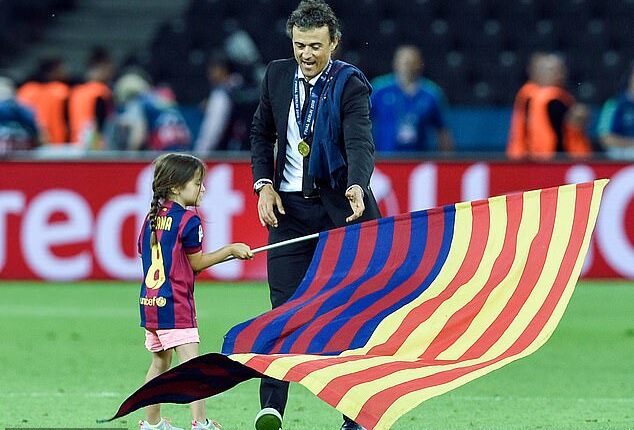 Xana plants a Barcelona flag in centre circle after her father won the 2015 Champions League