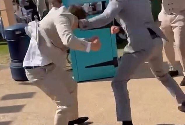 A shocking video has emerged online of two men, who were suited and booted, viciously swinging punches at one another, at the prestigious Berkshire event