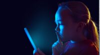 girl looking at screen in dark
