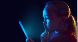 girl looking at screen in dark