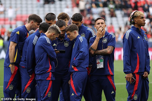 A group of Spanish players were seen huddled around a phone watching the French Open