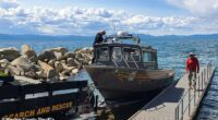 The two survivors of the deadly Lake Tahoe tragedy that claimed eight lives were wearing life jackets at the time of their rescue (pictured: search-and-rescue teams on Lake Tahoe)