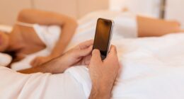 An expert has revealed five warning signs that might indicate your partner is spying on you through your phone (stock image)