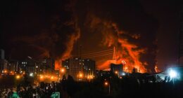 Fire and smoke rise into the sky after an Israeli attack on an oil depot in Tehran, Iran, at dawn on Sunday, June 15, 2025