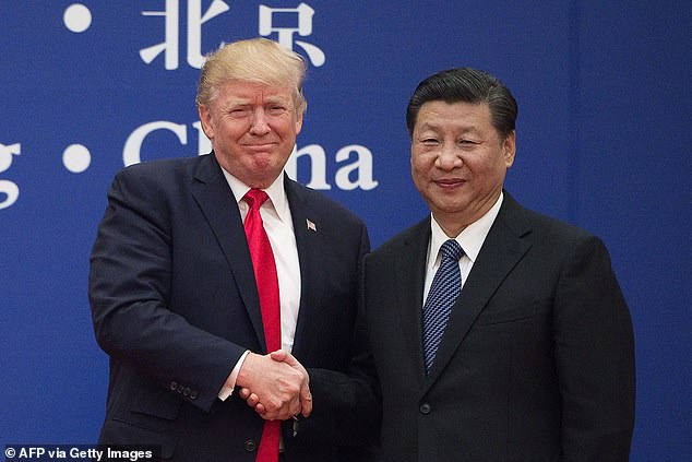 President Donald Trump (left) shakes hands with Chinese leader Xi Jinping (right) during his 2017 state visit to Beijing. During a call Thursday, Xi invited Trump to return to China, while Trump invited Xi to visit him in Washington, D.C.