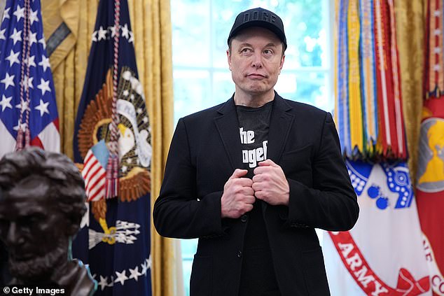 Tesla CEO Elon Musk listens as U.S. President Donald Trump speaks to reporters in the Oval Office