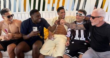 In a VIP cabana at the O Beach club in Ibiza, Jude Bellingham (centre) was photographed laughing with its owner Wayne Lineker (right), Gary's controversial younger brother