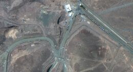 Picture taken on June 19 shows trucks positioned near the entrance of Iran's Fordow Fuel Enrichment Plant