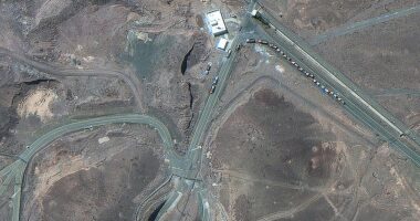 Picture taken on June 19 shows trucks positioned near the entrance of Iran's Fordow Fuel Enrichment Plant