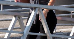 Kim Kardashian, 44, typically known for extremely dressy looks, was seen walking to Venice airport with a confusing grey top - which appeared to be a cross between a tube top and tank top thrown together - paired with black pants and white heels. Kim let her hair flow loosely but it seemed unkempt