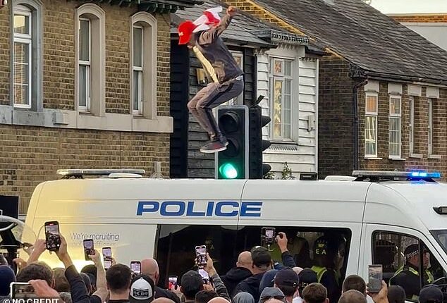 'Save Our Kids' protest turns violent: Thugs clash with police as residents with homemade banners gather at asylum hotel after migrant appears in court over schoolgirl sex assault