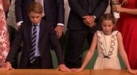 Prince George (pictured, left) and Princess Charlotte (pictured, right) appear to look disappointed after Alcaraz lost the Wimbledon men's final