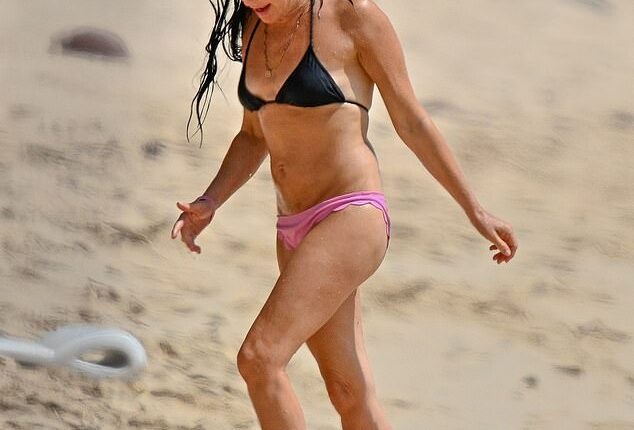 Andrea Corr turned heads in a mismatched bikini as she enjoyed a relaxing beach stroll in Barbados on Thursday