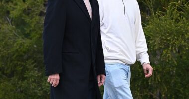 Australian Prime Minister Anthony Albanese and his son Nathan walk towards Parliament House in Canberra