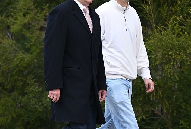 Australian Prime Minister Anthony Albanese and his son Nathan walk towards Parliament House in Canberra