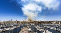 A fire currently burning in the hills north of Marseille, in the area of Les Pennes-Mirabeau, is producing thick smoke visible from the Vieux-Port on July 8, 2025 in Marseille, France