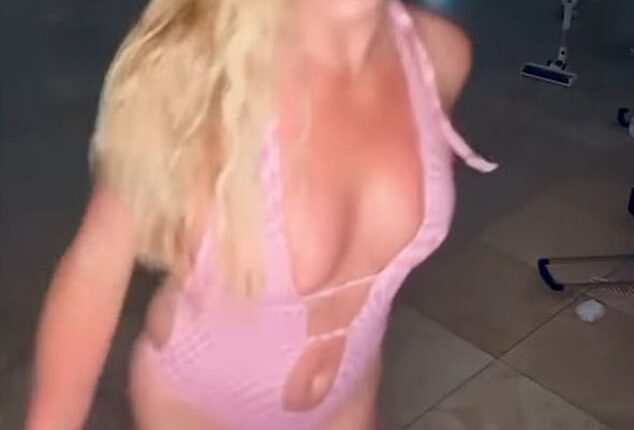 Britney Spears, 43, danced and twirled in a pink monokini and black boots in a video on social media as she announced a couple of bombshells regarding changes in her life on Sunday